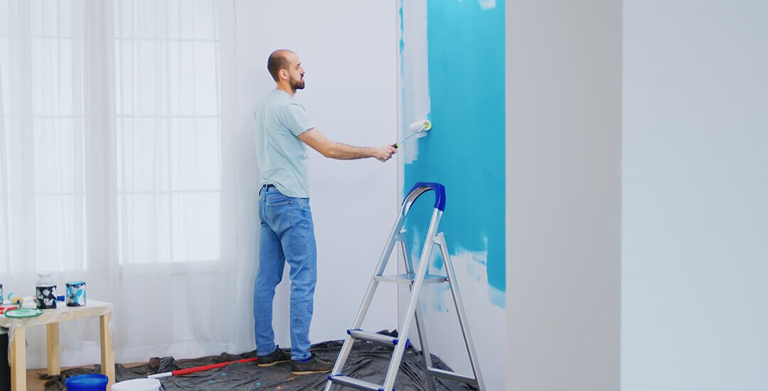 painting-apartment-wall-with-white-paint-using-roller-brush-handyman-renovating-apartment-redecoration-home-construction-while-renovating-improving-repair-decorating