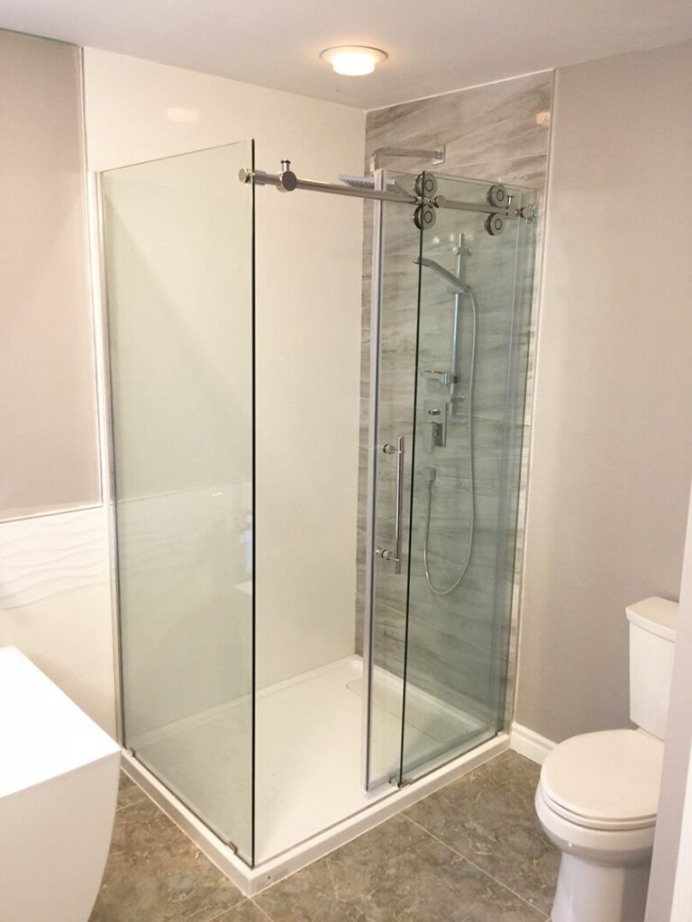 Clear glass shower enclosure with sliding door